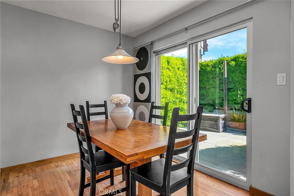Breakfast nook with pendant lamp and sliding door to rear patio.